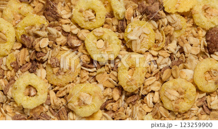 Crunchy breakfast cereal and oat granola mix, featuring puffed corn rings, toasted oats, and nuts. A nutritious and delicious option for a healthy meal. 123259900