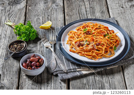 vegan whole grain pasta alla puttanesca on a plate vegan whole grain pasta alla puttanesca on a plate 123260113