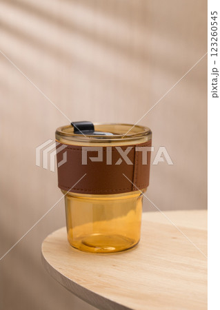 The amber glass tumbler with a brown leather sleeve a stylish and practical accessory. The amber glass tumbler with a brown leather sleeve a stylish and practical accessory. 123260545