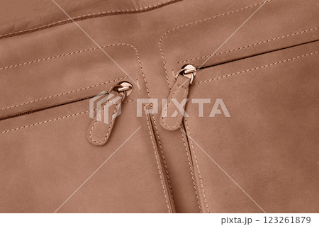 Stylish brown handbag featuring double zip pockets closeup Stylish brown handbag featuring double zip pockets closeup 123261879
