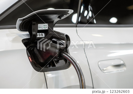 EV car connected to the charger, eco friendly technology EV car connected to the charger, eco friendly technology 123262603
