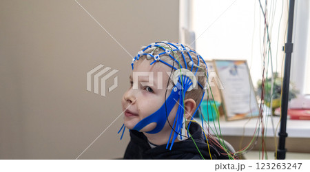 A boy's brain is examined on an EEG machine. Electroencephalogram is performed in a hospital laboratory to detect neurological diseases. Encephalogram for children 123263247
