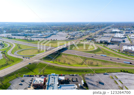 Aerial perspective of complex traffic interchange with busy roads, commercial areas, green spaces on America Aerial perspective of complex traffic interchange with busy roads, commercial areas, green spaces on America 123264700