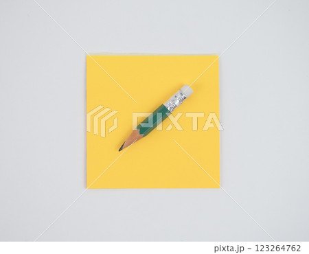 composition of yellow note and green pencil isolated on white composition of yellow note and green pencil isolated on white 123264762