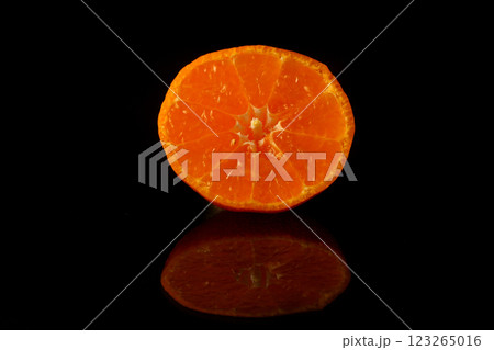 Slice of fresh tangerine isolated on black background	 123265016