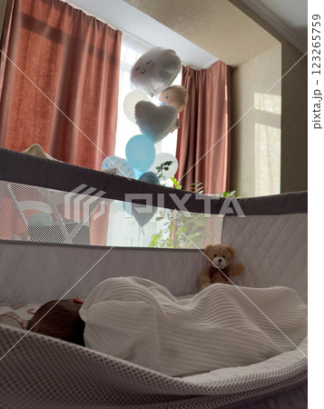Peaceful Baby Sleeping in Crib with Balloons Peaceful Baby Sleeping in Crib with Balloons 123265759