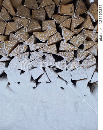 Snow-Covered Firewood Stack in Winter 123265825