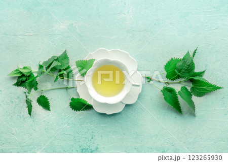 Nettle tea. Medicinal herbal tea with Urtica leaves. Fresh wild herb Nettle tea. Medicinal herbal tea with Urtica leaves. Fresh wild herb 123265930