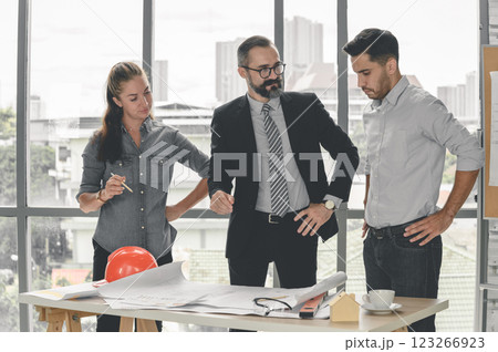 Construction engineer and architect check plan working with the blueprint on office worker conference site. Engineers team meeting for architectural project. Construction Concept. Construction engineer and architect check plan working with the blueprint on office worker conference site. Engineers team meeting for architectural project. Construction Concept. 123266923