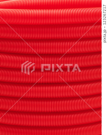 Plastic corrugated hose close-up. Red background, texture. 123267217