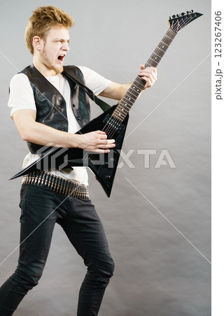 Young man playing electric guitar 123267406