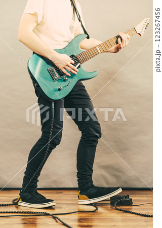 Man playing on electric guitar 123267456