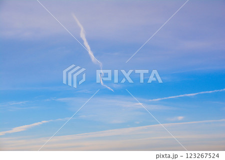 Blue sky with unique clouds. Plane trail on sky Blue sky with unique clouds. Plane trail on sky 123267524