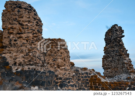 Abandoned castle. Castle ruins. Destroyed walls of an old fort. Old architecture. Abandoned castle. Castle ruins. Destroyed walls of an old fort. Old architecture. 123267543