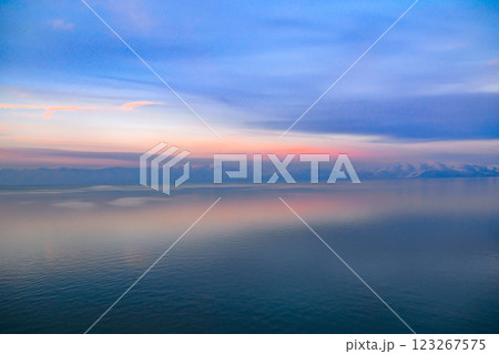 Beautiful sunset over the lake. Sunrise on the sea. Beautiful landscape with lake, mountains and sunset. Reflection in the water	 123267575