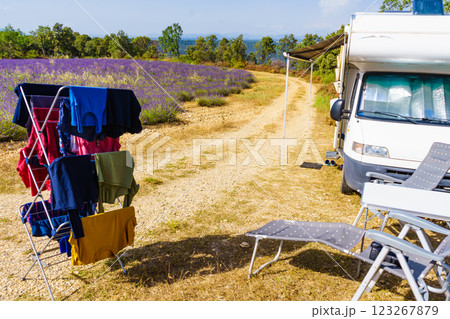 Clothes hanging to dry outdoors by camping car. Caravan vacation in France Clothes hanging to dry outdoors by camping car. Caravan vacation in France 123267879