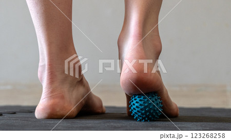 Blue spiky rubber massage ball for recovery massage. MFR ball for rehabilitation and health. Blue spiky rubber massage ball for recovery massage. MFR ball for rehabilitation and health. 123268258