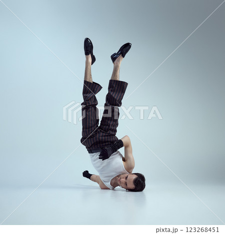 Young man with confident gaze and sculpted physique, exuding fashion energy highlight masculinity against gradient background. Young man with confident gaze and sculpted physique, exuding fashion energy highlight masculinity against gradient background. 123268451
