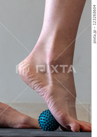 Blue spiky rubber massage ball for recovery massage. MFR ball for rehabilitation and health. Blue spiky rubber massage ball for recovery massage. MFR ball for rehabilitation and health. 123268604