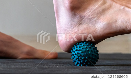 Blue spiky rubber massage ball for recovery massage. MFR ball for rehabilitation and health. Blue spiky rubber massage ball for recovery massage. MFR ball for rehabilitation and health. 123268606