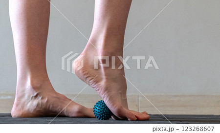 Blue spiky rubber massage ball for recovery massage. MFR ball for rehabilitation and health. Blue spiky rubber massage ball for recovery massage. MFR ball for rehabilitation and health. 123268607