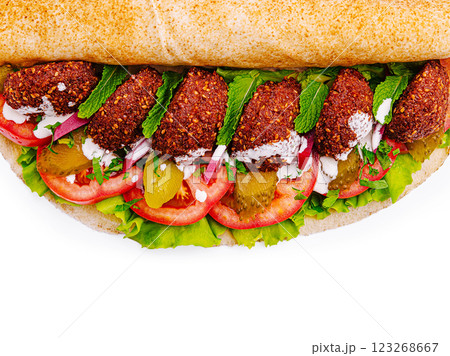 Fresh falafel wrap filled with vibrant vegetables and herbs 123268667