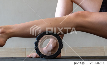 Black MFR roller for body. Recovery massage. MFR roll for rehabilitation and health. 123268734