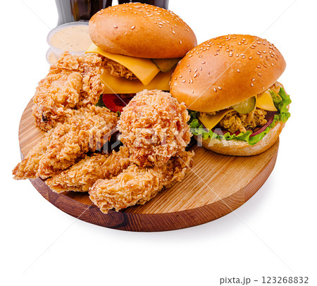 Delicious fried chicken and burgers served on a wooden platter 123268832