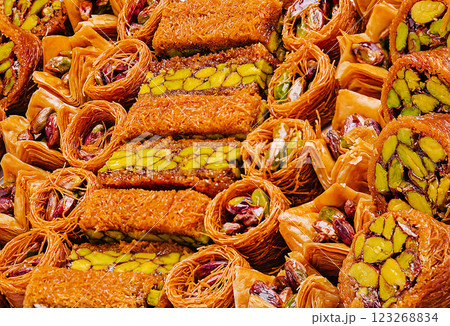 Sweet desserts made with pistachios and phyllo dough in market setting Sweet desserts made with pistachios and phyllo dough in market setting 123268834
