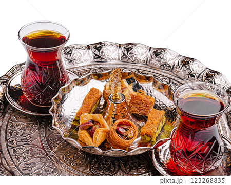 Delightful tea and pastry presentation on traditional tray 123268835