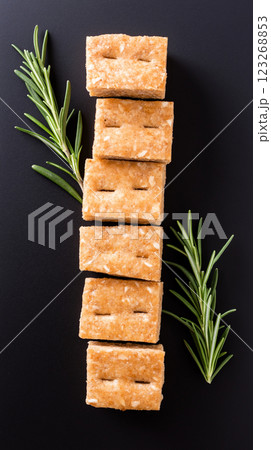 Crispy bulgur crackers with smoky paprika and rosemary on slate board. Rustic handmade appeal, soft natural light, and earthy tones. 123268853