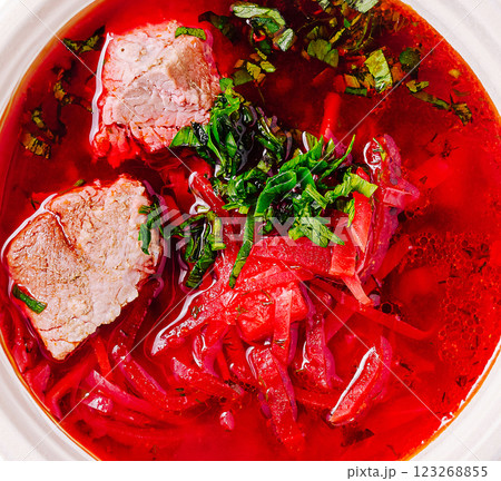 Bright borscht soup served with tender meat and fresh herbs 123268855