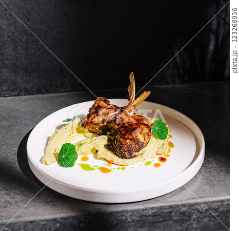Grilled lamb chops served on creamy puree with garnish 123268936