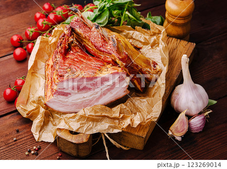 Deliciously prepared cured meat on wooden board in rustic setting Deliciously prepared cured meat on wooden board in rustic setting 123269014