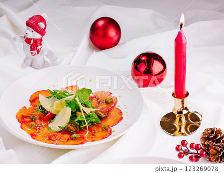 Holiday salad with decorative candle and seasonal ornaments Holiday salad with decorative candle and seasonal ornaments 123269078