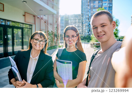 Selfie portrait female teacher with teenagers students, outdoors Selfie portrait female teacher with teenagers students, outdoors 123269994