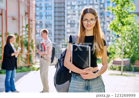 Portrait of young smiling female college student with backpack, outdoors Portrait of young smiling female college student with backpack, outdoors 123269999