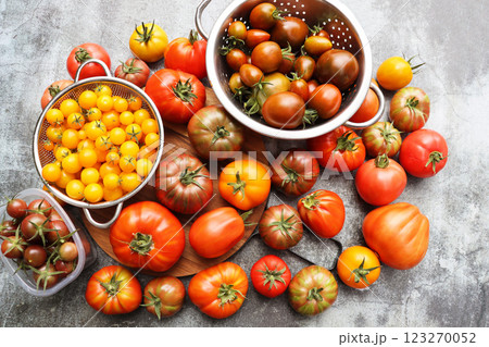 Background of fresh heirloom red tomatoes on cutting board, view from above, organic fruit. Space for text. Top view Background of fresh heirloom red tomatoes on cutting board, view from above, organic fruit. Space for text. Top view 123270052