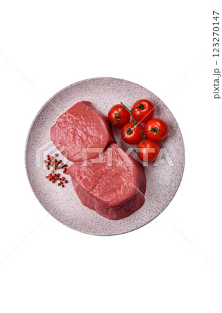 Raw beef eye steak round with salt, spices and herbs 123270147