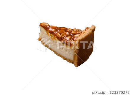 Delicious fresh cheesecake caramel peanut cake with cream and nuts Delicious fresh cheesecake caramel peanut cake with cream and nuts 123270272