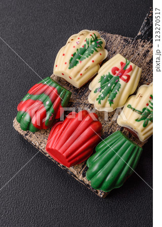 Sweet madeleine sponge cookies covered with colored chocolate 123270517