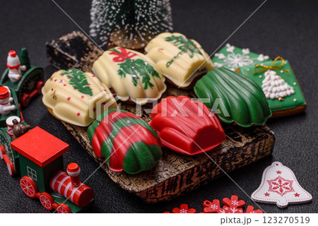 Sweet madeleine sponge cookies covered with colored chocolate 123270519