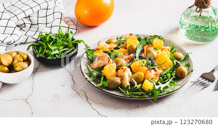 Vegetarian salad with cauliflower, orange, arugula and olives on a plate web banner 123270680