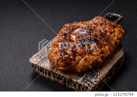 Juicy pork steak baked on the grill with salt, spices and herbs 123270794