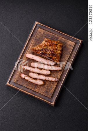 Juicy pork steak baked on the grill with salt, spices and herbs 123270816