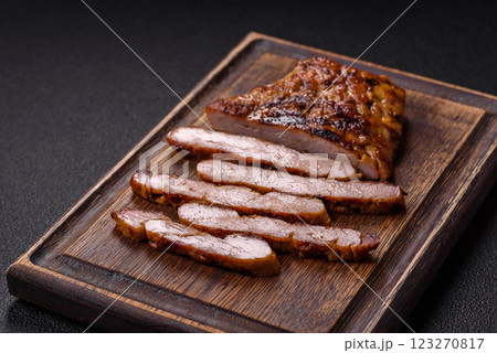 Juicy pork steak baked on the grill with salt, spices and herbs Juicy pork steak baked on the grill with salt, spices and herbs 123270817