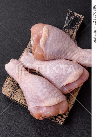 Raw chicken legs with salt, spices and herbs Raw chicken legs with salt, spices and herbs 123270896