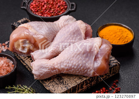Raw chicken legs with salt, spices and herbs Raw chicken legs with salt, spices and herbs 123270897