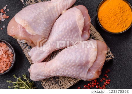 Raw chicken legs with salt, spices and herbs Raw chicken legs with salt, spices and herbs 123270898