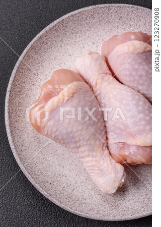 Raw chicken legs with salt, spices and herbs Raw chicken legs with salt, spices and herbs 123270908
